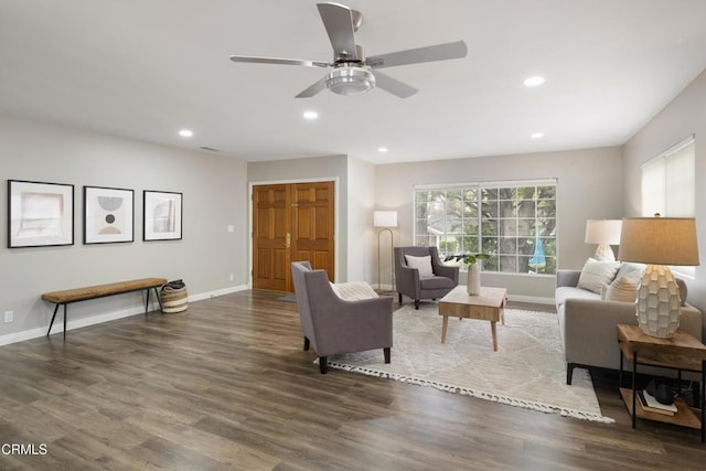 living area with a ceiling fan, recessed lighting, wood finished floors, and baseboards