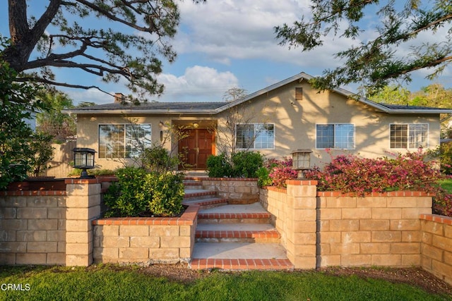 single story home featuring stucco siding