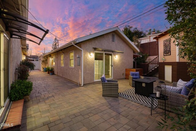 view of patio / terrace featuring an outdoor living space and fence