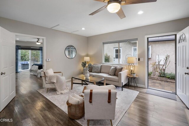 living area featuring recessed lighting, baseboards, ceiling fan, and wood-type flooring