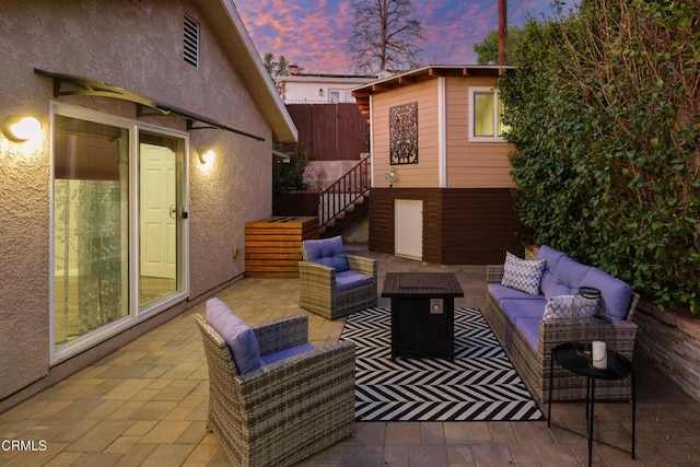 view of patio / terrace featuring an outdoor hangout area, an outdoor structure, stairs, and fence