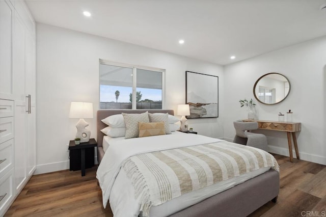 bedroom with recessed lighting, baseboards, and wood finished floors