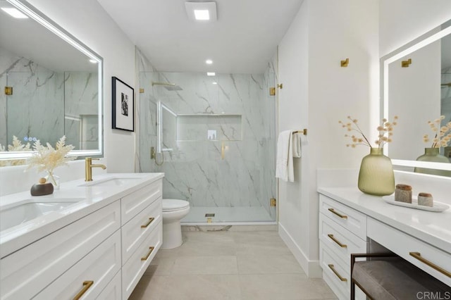 full bath featuring a marble finish shower, double vanity, toilet, and a sink