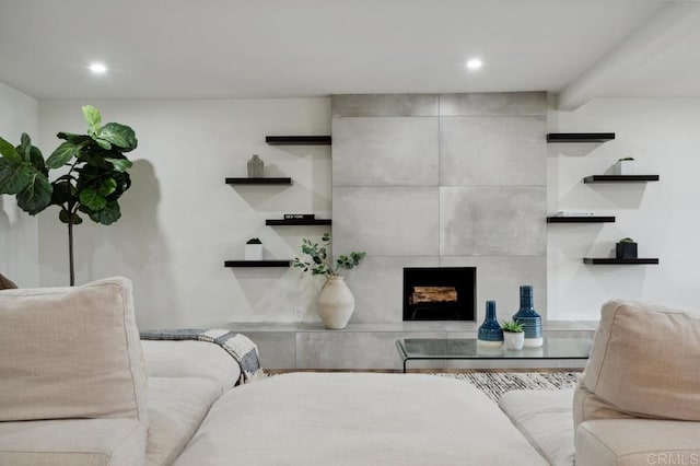 living area featuring recessed lighting and a tiled fireplace