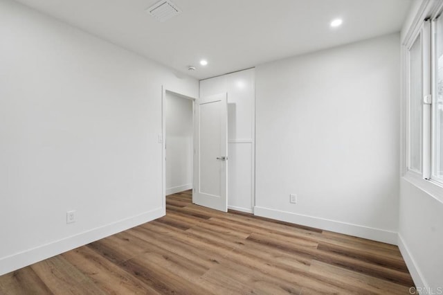 unfurnished bedroom featuring recessed lighting, baseboards, and wood finished floors