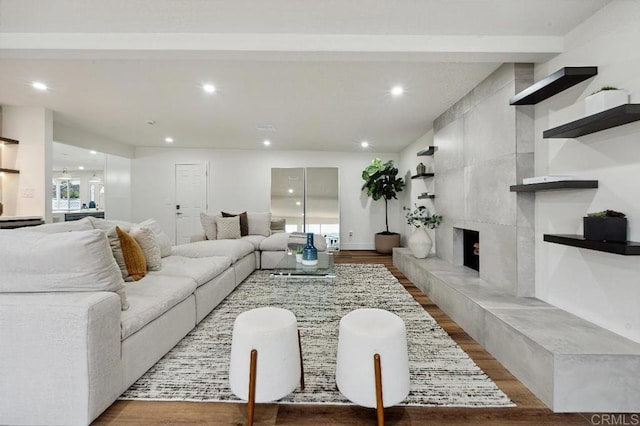 living room featuring recessed lighting, wood finished floors, and a premium fireplace