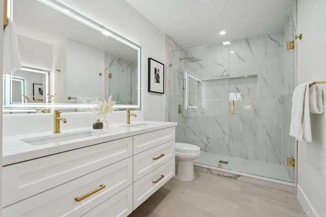 full bath with a marble finish shower, toilet, and a sink