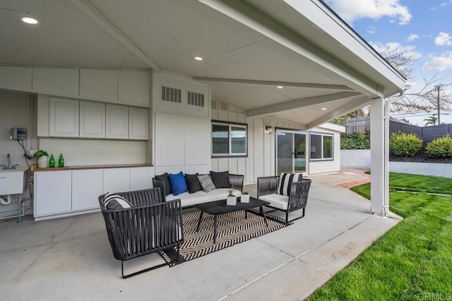 view of patio / terrace with visible vents, an outdoor living space, and a sink