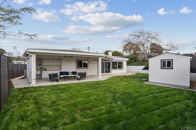 rear view of house with a fenced backyard, a patio, outdoor lounge area, and an outdoor structure