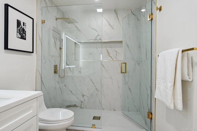 bathroom featuring vanity, toilet, and a marble finish shower