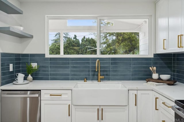 kitchen with open shelves, a sink, decorative backsplash, white cabinets, and stainless steel dishwasher