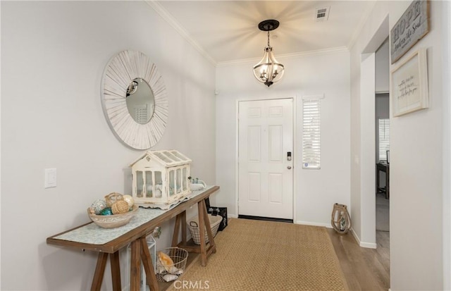 244 Country Club Dr, Calimesa, CA 92320 - foyer featuring ornamental molding, wood finished floors, baseboards, and a chandelier