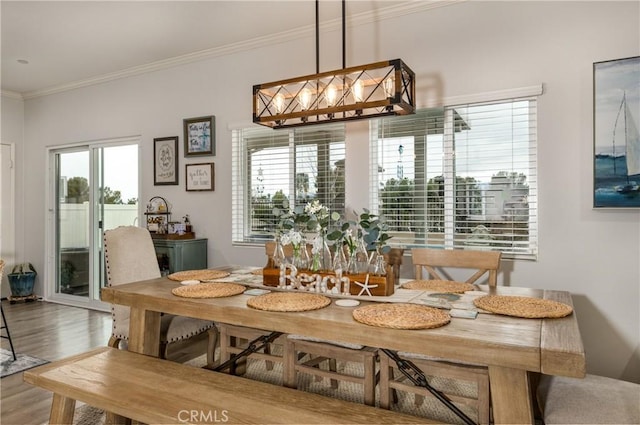 dining area featuring crown molding and wood finished floors