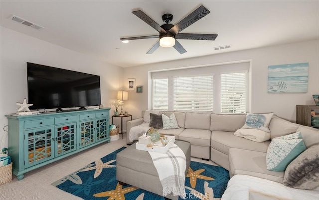 carpeted living area with a ceiling fan and visible vents