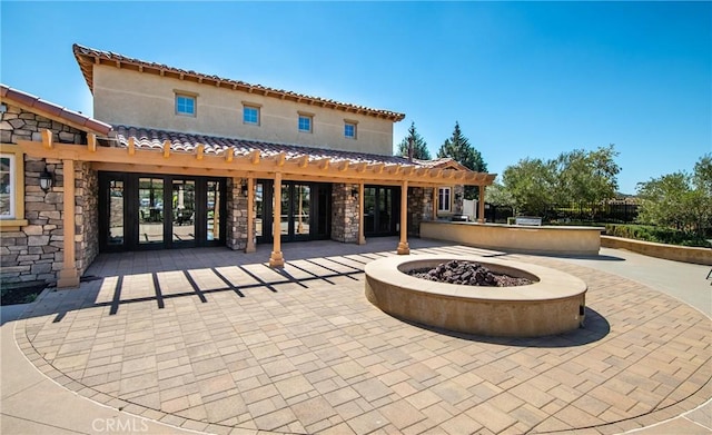 244 Country Club Dr, Calimesa, CA 92320 - view of patio / terrace with a fire pit, french doors, and an outdoor kitchen
