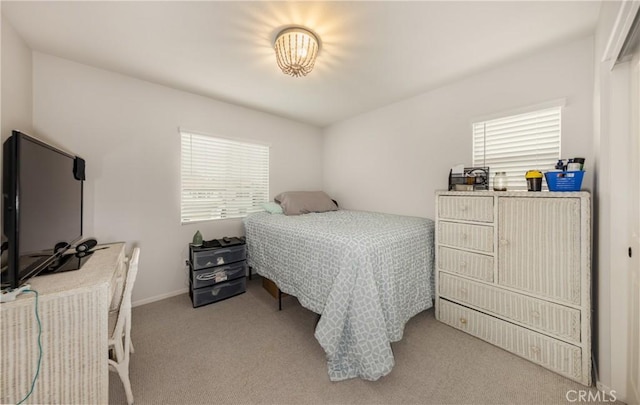 carpeted bedroom with baseboards