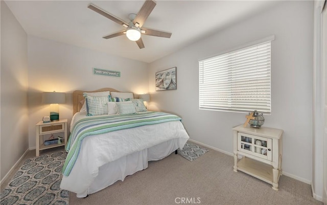 carpeted bedroom with baseboards and a ceiling fan