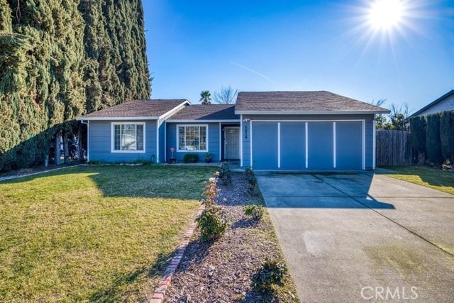 single story home with a garage, driveway, a front lawn, and fence