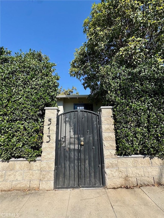 view of gate with fence