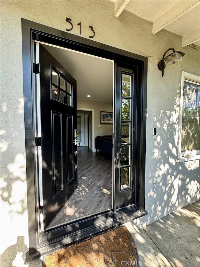 doorway to property with stucco siding