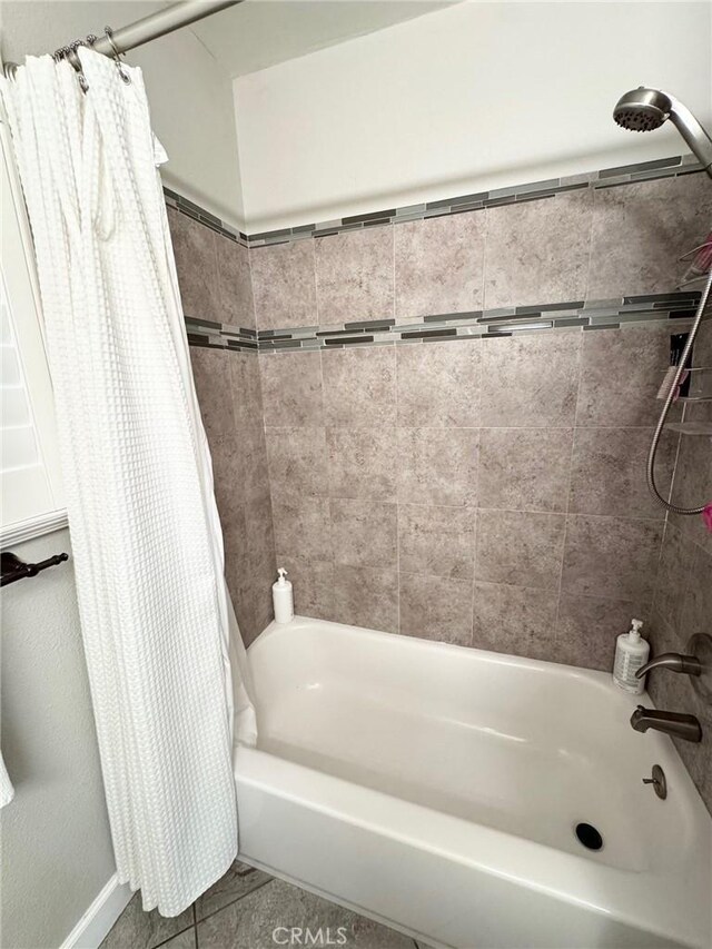 full bathroom with shower / tub combo with curtain and tile patterned flooring