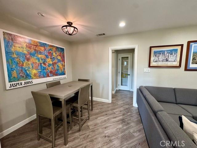 dining area featuring recessed lighting, visible vents, baseboards, and wood finished floors