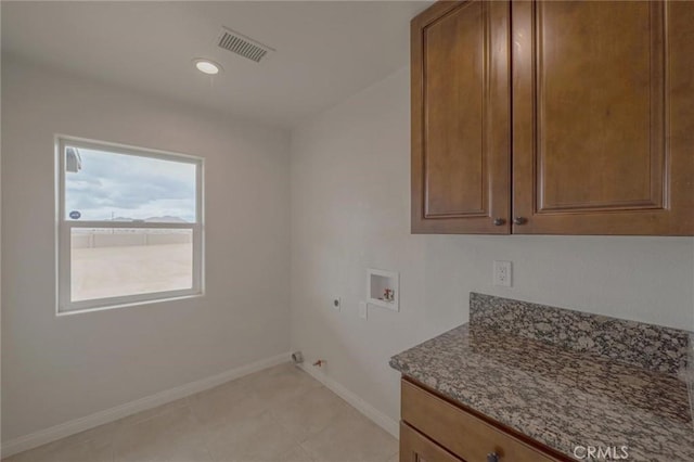 laundry room with visible vents, washer hookup, hookup for a gas dryer, cabinet space, and baseboards