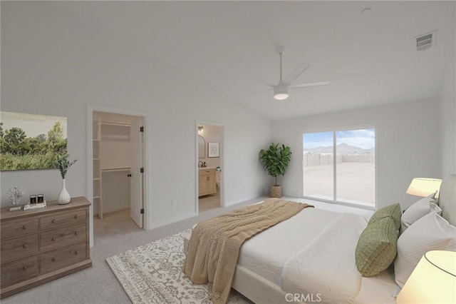 bedroom featuring visible vents, a walk in closet, lofted ceiling, light carpet, and a ceiling fan