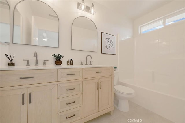 full bathroom featuring tile patterned flooring, double vanity, toilet, and a sink