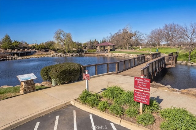 view of dock featuring a gazebo and a water view