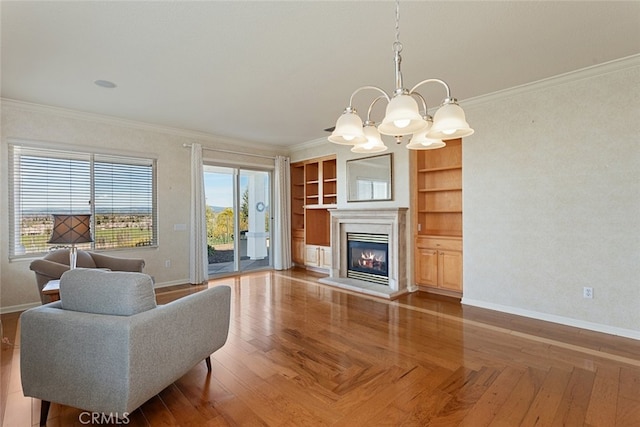 living area featuring a notable chandelier, baseboards, and ornamental molding