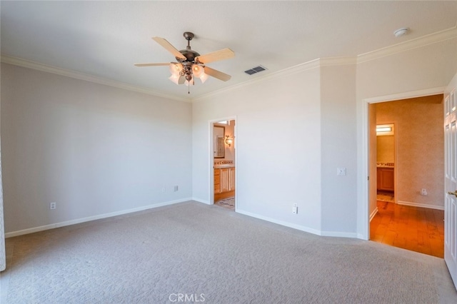 unfurnished bedroom featuring visible vents, baseboards, and crown molding