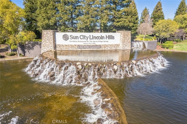 community sign with a water view