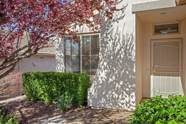 doorway to property with stucco siding