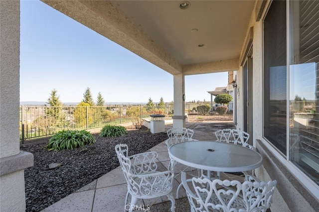 view of patio / terrace featuring outdoor dining space and fence