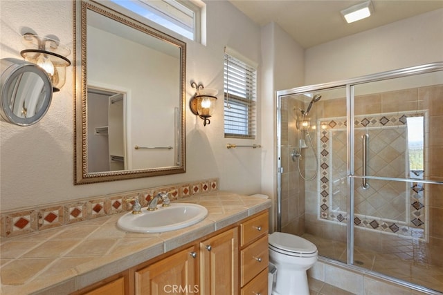 full bathroom with toilet, a stall shower, vanity, and tile patterned flooring