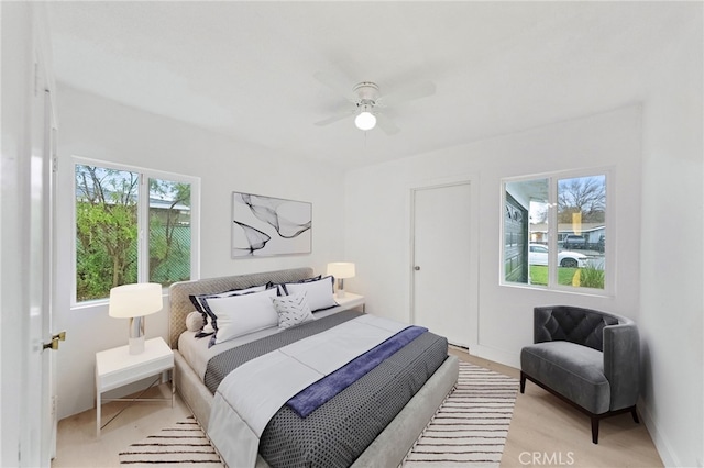 bedroom featuring multiple windows and a ceiling fan