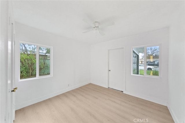 unfurnished room with light wood-style flooring, baseboards, and ceiling fan