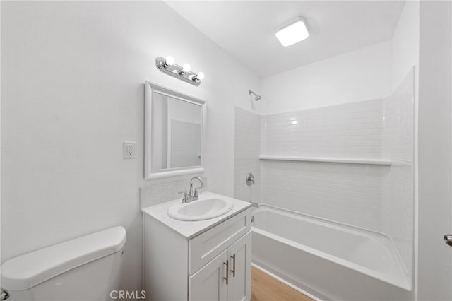 bathroom featuring toilet, vanity, and shower / bathing tub combination