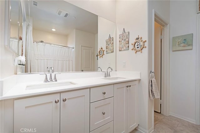 full bath featuring double vanity, visible vents, and a sink