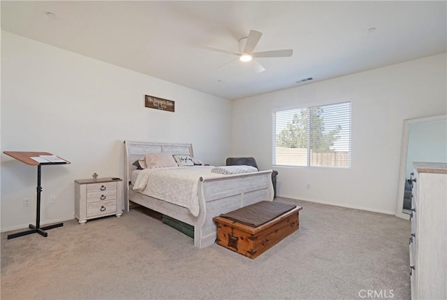 carpeted bedroom with visible vents, baseboards, and a ceiling fan