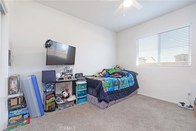 carpeted bedroom featuring baseboards and ceiling fan