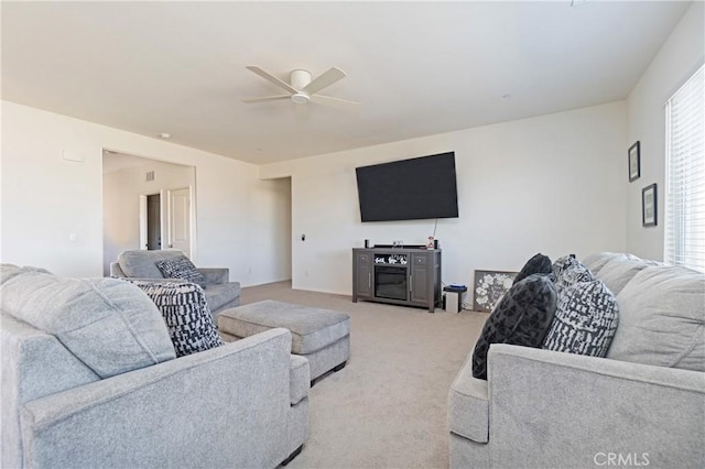 living room with light carpet and a ceiling fan