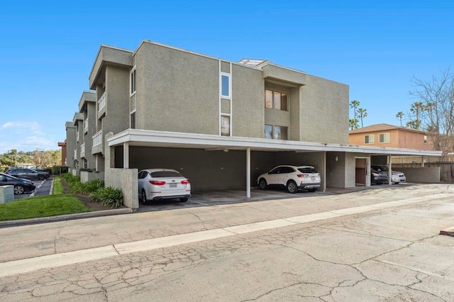 view of building exterior with covered parking