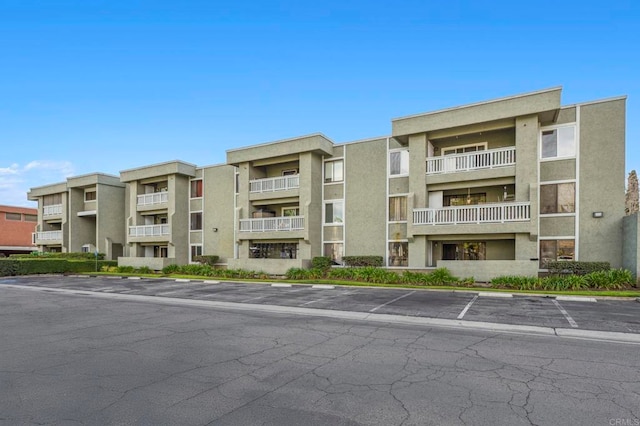 view of property featuring uncovered parking