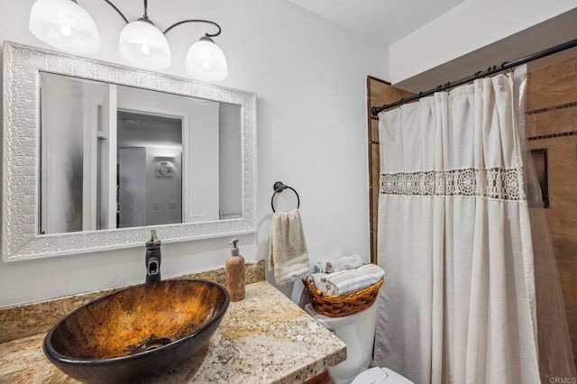 bathroom with vanity, a shower with shower curtain, and toilet