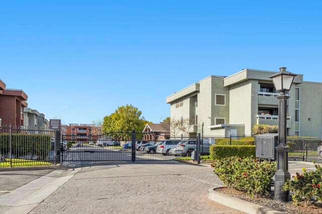 1020 E Washington Ave Unit 88, Escondido, CA 92025 - view of decorative street featuring a gated entry, curbs, a gate, and a residential view