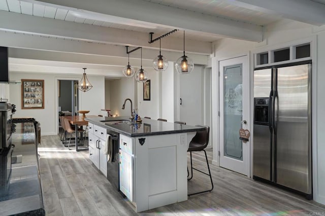 kitchen with dishwasher, wood finished floors, stainless steel fridge with ice dispenser, and a sink