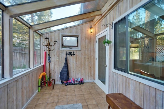 sunroom / solarium featuring lofted ceiling and plenty of natural light