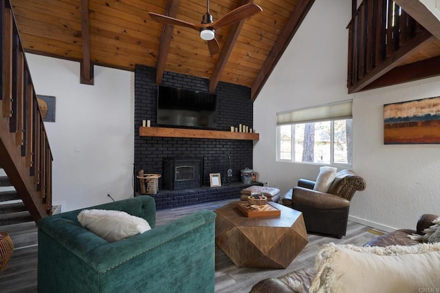 living room featuring ceiling fan, stairway, beam ceiling, wooden ceiling, and wood finished floors